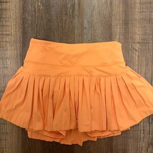 GoldHinge Orange Pleated Mini Skirt